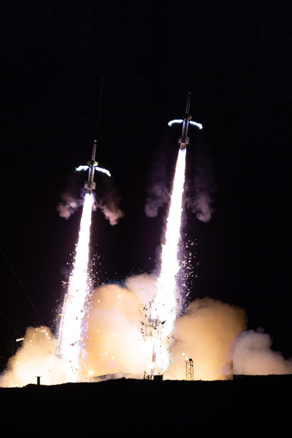 The TRICE-2 sounding rockets launched 2 minutes apart from the Andoya Space Center in Andenes, Norway, on Dec. 8, 2018. Motors fired on the sides of the first stages to spin the rockets and help stabilize their flight. <cite>Jamie Adkins/NASA</cite>